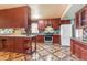 This spacious kitchen features dark wood cabinets, stylish tile countertops, and a large center island at 4632 W Marlette Ave, Glendale, AZ 85301