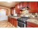 Close up of kitchen features, granite countertops, tile backsplash, and stainless appliances at 4632 W Marlette Ave, Glendale, AZ 85301