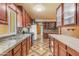 Well-lit kitchen with granite countertops, wood cabinets, tile backsplash, and stainless appliances at 4632 W Marlette Ave, Glendale, AZ 85301