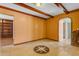 Living room with decorative floors, exposed ceiling beams, and arched doorway at 4632 W Marlette Ave, Glendale, AZ 85301