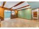 Open-concept living area with tile floors, exposed beams, and an archway into the next room at 4632 W Marlette Ave, Glendale, AZ 85301