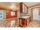 Open-concept room with wood cabinetry, tile flooring, and a chandelier at 4632 W Marlette Ave, Glendale, AZ 85301