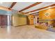 Spacious living room featuring a unique fireplace, exposed beams, and tile flooring at 4632 W Marlette Ave, Glendale, AZ 85301