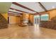 Spacious living room featuring a unique fireplace, exposed beams, and tile flooring at 4632 W Marlette Ave, Glendale, AZ 85301