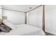 Bright, minimalist bedroom with a canopy bed, neutral colors, and a door leading to the bathroom at 48388 N Duran Way, Gold Canyon, AZ 85118