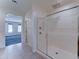 Bright bathroom with a spacious glass shower, tile floors, and access to the main bedroom at 4927 S Tune --, Mesa, AZ 85212