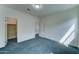 Bedroom with neutral carpeting and access to a walk-in closet and bathroom at 4927 S Tune --, Mesa, AZ 85212
