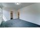 Bedroom with neutral carpeting and access to a walk-in closet and bathroom at 4927 S Tune --, Mesa, AZ 85212