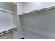 Bright closet boasts ample storage space with wooden rods and shelving at 4927 S Tune --, Mesa, AZ 85212