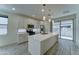 Modern kitchen with stainless steel appliances, a large island, and white cabinets at 4927 S Tune --, Mesa, AZ 85212