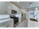 Well-equipped kitchen featuring stainless steel appliances, white cabinetry and quartz countertops at 4927 S Tune --, Mesa, AZ 85212