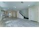 Bright living room with modern tile flooring and white staircase to the second floor at 4927 S Tune --, Mesa, AZ 85212
