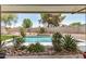 Tranquil backyard featuring a sparkling pool area with desert landscaping elements at 527 N Criss St, Chandler, AZ 85226