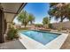 Serene backyard oasis featuring a sparkling pool, desert landscaping, and covered patio area at 527 N Criss St, Chandler, AZ 85226