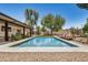 Gorgeous backyard with a refreshing pool, desert landscaping, and covered patio at 527 N Criss St, Chandler, AZ 85226