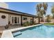 Relaxing backyard featuring a sparkling pool, lush landscaping, and covered patio at 527 N Criss St, Chandler, AZ 85226
