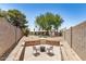 Expansive backyard featuring a fire pit area, desert landscaping, and a glimpse of the inviting pool at 527 N Criss St, Chandler, AZ 85226