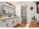 Stylish bathroom features decorative wallpaper, modern vanity, and a glass-enclosed shower at 527 N Criss St, Chandler, AZ 85226