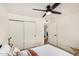 Bedroom with carpet and a ceiling fan features an adjacent room with terracotta floors at 527 N Criss St, Chandler, AZ 85226