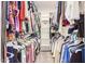 Walk-in closet with built in shelving and organized hanging clothes at 527 N Criss St, Chandler, AZ 85226