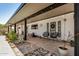 Inviting covered patio with neutral concrete, stone landscaping, and comfortable seating area at 527 N Criss St, Chandler, AZ 85226