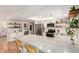 Bright kitchen features stainless appliances, white cabinetry, subway tile backsplash, and a large island with barstool seating at 527 N Criss St, Chandler, AZ 85226