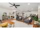 Open-concept living space with tile floors, multiple seating areas, and a clear view into kitchen at 527 N Criss St, Chandler, AZ 85226