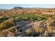 Community basketball court surrounded by lush green lawns and desert landscaping, with mountain views in the distance at 6251 E Bramble Berry Ln, Cave Creek, AZ 85331