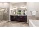 Modern bathroom featuring a double sink vanity, a glass-enclosed shower, and stylish tile flooring at 6251 E Bramble Berry Ln, Cave Creek, AZ 85331