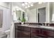 Bathroom with dual sinks, granite countertops, wood cabinets, and a shower and tub at 6251 E Bramble Berry Ln, Cave Creek, AZ 85331