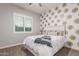 Charming bedroom with a feature wall, comfortable bed, and bright window, perfect for rest and relaxation at 6251 E Bramble Berry Ln, Cave Creek, AZ 85331