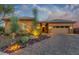 Charming home featuring a paver driveway, desert landscaping, and warm exterior lighting at 6251 E Bramble Berry Ln, Cave Creek, AZ 85331