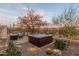 Enjoy desert landscaping, cactus, and outdoor furniture in this private backyard setting with a hot tub at 6251 E Bramble Berry Ln, Cave Creek, AZ 85331