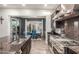 Gourmet kitchen featuring dark granite countertops, stainless steel appliances, and an open view into the dining area at 6251 E Bramble Berry Ln, Cave Creek, AZ 85331