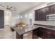 Open concept kitchen and living room featuring stainless steel appliances and dark wood cabinetry at 6251 E Bramble Berry Ln, Cave Creek, AZ 85331
