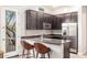 Kitchen with granite countertops, stainless steel appliances, dark cabinets, and counter seating at 6251 E Bramble Berry Ln, Cave Creek, AZ 85331