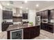 Modern kitchen with stainless steel appliances, granite countertops, and dark wood cabinets at 6251 E Bramble Berry Ln, Cave Creek, AZ 85331