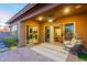 Inviting covered patio with stylish seating, rug, and views into the home's kitchen and living area at 6251 E Bramble Berry Ln, Cave Creek, AZ 85331