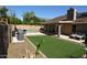 Backyard features a patio, outdoor furniture, artificial grass, pool and spa at 6352 W Campo Bello Dr, Glendale, AZ 85308