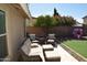Inviting backyard patio features stylish seating, a charming playhouse, and lush green artificial turf at 6352 W Campo Bello Dr, Glendale, AZ 85308