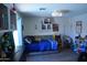 Bright bedroom featuring decor, a daybed, gray wood laminate flooring, and an arcade game at 6352 W Campo Bello Dr, Glendale, AZ 85308