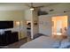Spacious bedroom with a comfortable bed, dark wood furniture, and a view towards the kitchen at 6352 W Campo Bello Dr, Glendale, AZ 85308