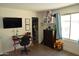 The bedroom features wood laminate flooring, decor, a closet, a TV and a workstation at 6352 W Campo Bello Dr, Glendale, AZ 85308