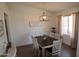 Cozy dining room featuring a classic chandelier and a farmhouse-style dining set at 6352 W Campo Bello Dr, Glendale, AZ 85308