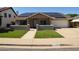 Inviting single-story home featuring a well-manicured lawn and modern solar panels on the roof at 6352 W Campo Bello Dr, Glendale, AZ 85308