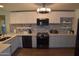Well-lit kitchen features stainless steel appliances, light countertops, white cabinets, and a decorative backsplash at 6352 W Campo Bello Dr, Glendale, AZ 85308