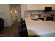 Bright kitchen showcases long countertops and a modern sink and faucet, with barstool seating for casual dining at 6352 W Campo Bello Dr, Glendale, AZ 85308