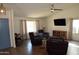 Bright living room with wood flooring, a ceiling fan, and comfortable seating at 6352 W Campo Bello Dr, Glendale, AZ 85308