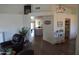 Open-concept living space flowing into dining area, featuring wood floors and natural light at 6352 W Campo Bello Dr, Glendale, AZ 85308