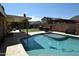 Backyard pool and covered patio offers great outdoor living with artificial grass at 6352 W Campo Bello Dr, Glendale, AZ 85308